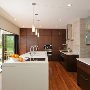 Mid-sized contemporary open concept kitchen ideas - Inspiration for a mid-sized contemporary l-shaped light wood floor open concept kitchen remodel in Chicago with flat-panel cabinets, dark wood cabinets, beige backsplash, an island, an integrated sink, quartz countertops, paneled appliances and stone tile backsplash