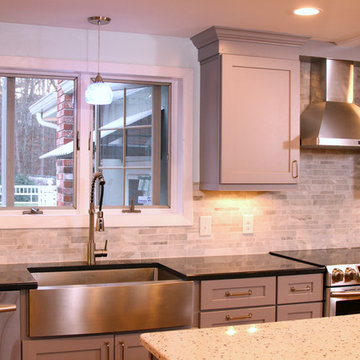 Modern Kitchen with gray cabinetry and stainless steel oven hood