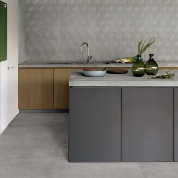 Modern kitchen with lightly textured cement look porcelain tile backsplash