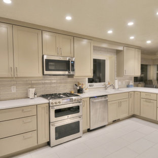 Mid-sized modern open concept kitchen photos - Inspiration for a mid-sized modern l-shaped porcelain tile open concept kitchen remodel in Salt Lake City with an undermount sink, flat-panel cabinets, gray cabinets, quartz countertops, gray backsplash, porcelain backsplash, stainless steel appliances and an island