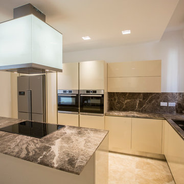 Modern kitchen with marble counter-top and backsplash