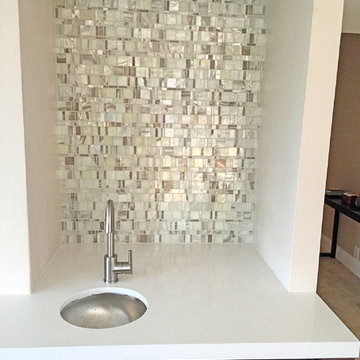 Modern kitchen with opal glass mosaic backsplash and white counter