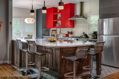 Photo of a medium sized galley open plan kitchen in Nashville with a submerged sink, flat-panel cabinets, red cabinets, engineered stone countertops, white splashback, glass tiled splashback, stainless steel appliances, porcelain flooring, an island, multi-coloured floors and white worktops.