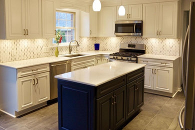 Example of a mid-sized classic l-shaped porcelain tile and brown floor eat-in kitchen design in Other with a double-bowl sink, raised-panel cabinets, white cabinets, quartz countertops, multicolored backsplash, mosaic tile backsplash, stainless steel appliances, an island and white countertops