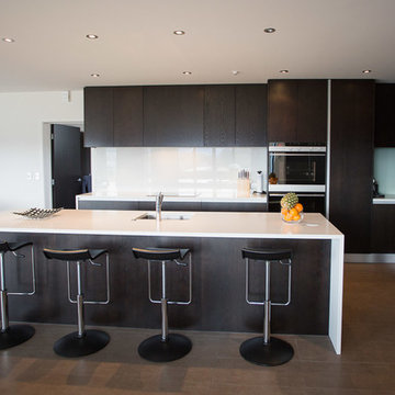 Modern Kitchen with White Benchtops & Dark Wood