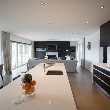 Modern Kitchen with White Benchtops & Dark Wood