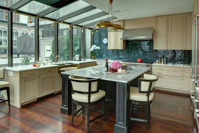 Open concept kitchen - mid-sized contemporary u-shaped dark wood floor and brown floor open concept kitchen idea in New York with a farmhouse sink, shaker cabinets, light wood cabinets, marble countertops, green backsplash, subway tile backsplash, stainless steel appliances and an island