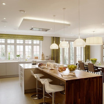 Modern, large Kitchen with barstools and Flos Lighting