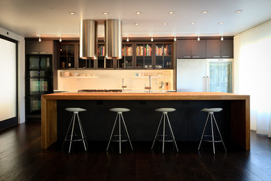 Mid-sized minimalist single-wall dark wood floor open concept kitchen photo in Toronto with an undermount sink, flat-panel cabinets, gray cabinets, laminate countertops, white backsplash and stainless steel appliances