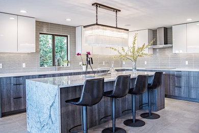 Inspiration for a large contemporary l-shaped gray floor eat-in kitchen remodel in Seattle with flat-panel cabinets, white cabinets, gray backsplash, an island, white countertops and glass tile backsplash
