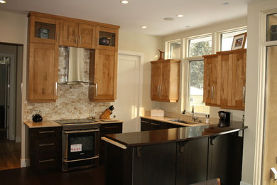 Foto på ett avskilt, litet funkis u-kök, med en undermonterad diskho, skåp i shakerstil, skåp i mellenmörkt trä, granitbänkskiva, beige stänkskydd, stänkskydd i stenkakel, rostfria vitvaror, mörkt trägolv och en halv köksö