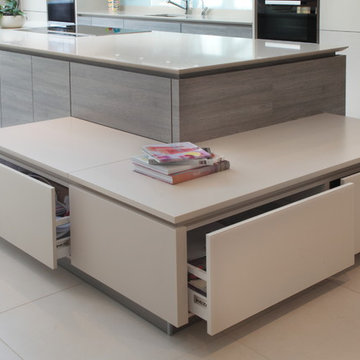 Modern matt cashmere & grey wood effect kitchen with unique storage solutions