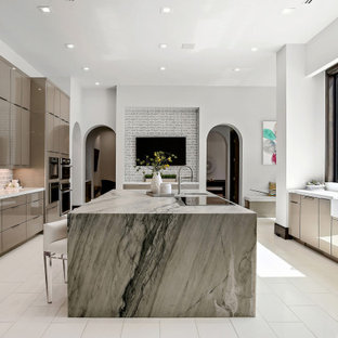 Contemporary u-shaped eat-in kitchen in Houston with a farmhouse sink, flat-panel cabinets, beige cabinets, grey splashback, panelled appliances, with island, white floor and multi-coloured benchtop.