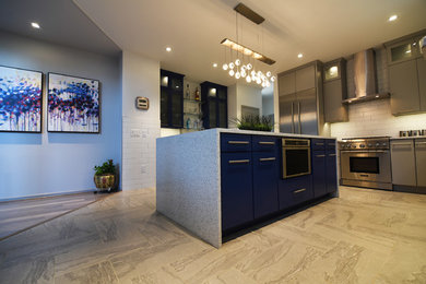 Eat-in kitchen - large modern u-shaped porcelain tile and gray floor eat-in kitchen idea in Baltimore with a farmhouse sink, flat-panel cabinets, blue cabinets, quartz countertops, white backsplash, porcelain backsplash, stainless steel appliances and an island