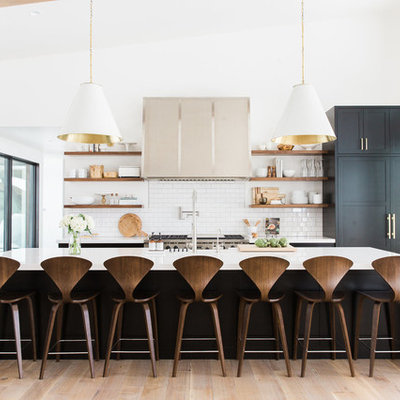 Kitchen - transitional light wood floor kitchen idea in Salt Lake City with white backsplash, subway tile backsplash, an island, open cabinets and paneled appliances
