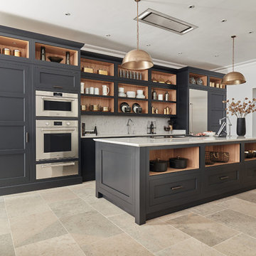 Modern navy blue cabinets with gold accents and Sub-Zero and Wolf appliances