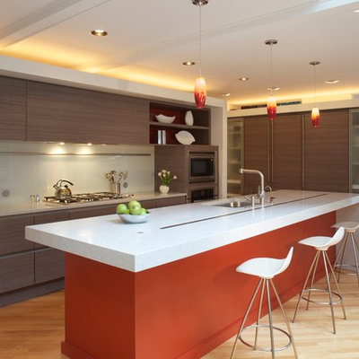 Kitchen - modern l-shaped kitchen idea in DC Metro with an undermount sink, flat-panel cabinets, glass sheet backsplash and paneled appliances