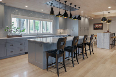 Exempel på ett stort modernt grå grått kök, med luckor med infälld panel, flera köksöar, en rustik diskho, rostfria vitvaror, ljust trägolv, brunt golv, bänkskiva i rostfritt stål, grå skåp och grått stänkskydd