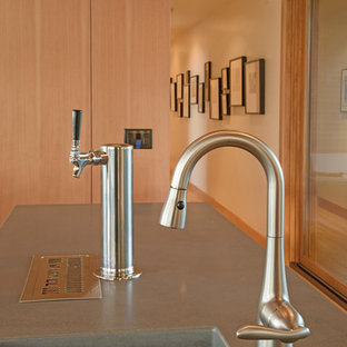 Inspiration for a large modern open plan kitchen in Other with an undermount sink, flat-panel cabinets, medium wood cabinets, concrete benchtops, green splashback, glass tile splashback, stainless steel appliances, bamboo floors, multiple islands and grey benchtop.