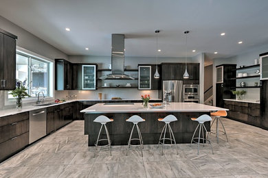 Inspiration for a modern porcelain tile kitchen remodel in Indianapolis with a single-bowl sink, flat-panel cabinets, dark wood cabinets, quartz countertops, gray backsplash, glass tile backsplash, stainless steel appliances and an island