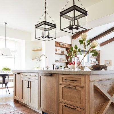 Example of a mid-sized tuscan medium tone wood floor and brown floor open concept kitchen design in San Francisco with a single-bowl sink, shaker cabinets, light wood cabinets, quartzite countertops, multicolored backsplash, ceramic backsplash, paneled appliances, an island and beige countertops