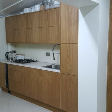 Modern style natural Oak veneer kitchen.