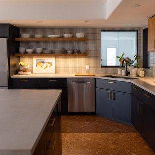 Photo of a mid-sized contemporary eat-in kitchen in Denver with a drop-in sink, flat-panel cabinets, blue cabinets, concrete benchtops, white splashback, subway tile splashback, stainless steel appliances, cork floors, with island, brown floor and white benchtop.