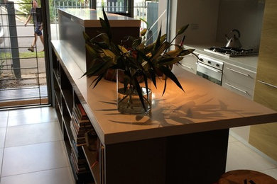 Zweizeilige, Kleine Moderne Wohnküche mit Doppelwaschbecken, grauen Schränken, Kalkstein-Arbeitsplatte, Küchengeräten aus Edelstahl und Keramikboden in Sydney
