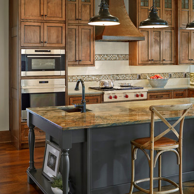 Inspiration for a timeless dark wood floor kitchen remodel in Dallas with recessed-panel cabinets, medium tone wood cabinets, white backsplash, stainless steel appliances and an island
