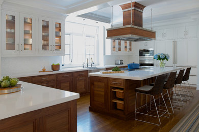 Kitchen - coastal dark wood floor kitchen idea in Dallas with a farmhouse sink, recessed-panel cabinets, dark wood cabinets, quartz countertops, white backsplash, glass tile backsplash, stainless steel appliances, an island and white countertops