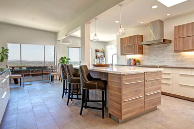 Inspiration for a large transitional u-shaped porcelain tile eat-in kitchen remodel in San Diego with an undermount sink, flat-panel cabinets, medium tone wood cabinets, quartz countertops, white backsplash, stainless steel appliances and an island