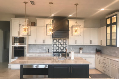 Example of a huge transitional u-shaped travertine floor and white floor kitchen design in Jacksonville with an undermount sink, raised-panel cabinets, white cabinets, quartzite countertops, white backsplash, marble backsplash, paneled appliances, two islands and white countertops