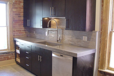 Modern update to brick bungalo kichen with concrete counters and integrated sink