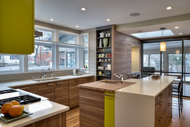 Example of a large trendy u-shaped medium tone wood floor and brown floor eat-in kitchen design in Chicago with an undermount sink, flat-panel cabinets, medium tone wood cabinets, quartz countertops, beige backsplash, mosaic tile backsplash, stainless steel appliances and an island