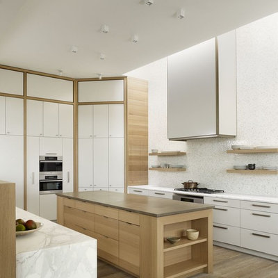 Trendy kitchen photo in Austin with mosaic tile backsplash, stainless steel appliances, white backsplash, flat-panel cabinets and white cabinets