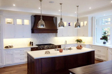 Large modern l-shaped kitchen/diner in Toronto with recessed-panel cabinets, white cabinets, engineered stone countertops, grey splashback, mosaic tiled splashback, an island, a double-bowl sink, dark hardwood flooring and brown floors.