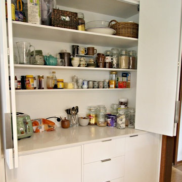 Modern White Kitchen- Bi-fold appliance cabinet