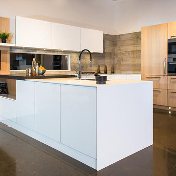 Modern white kitchen with accent concrete wall panelling