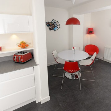Modern white kitchen with accent red splashback