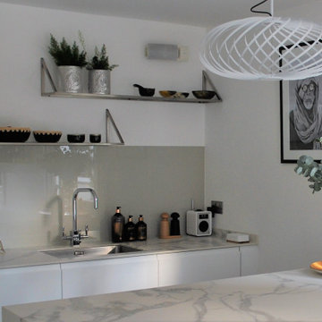 Modern White landless kitchen with marble style worktop