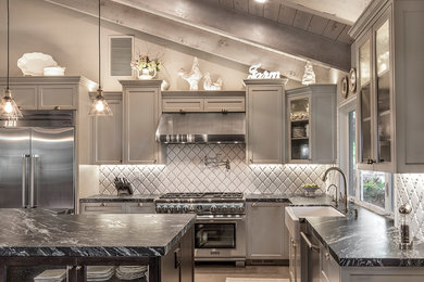 Example of a large mid-century modern l-shaped open concept kitchen design in Sacramento with a farmhouse sink, recessed-panel cabinets, gray cabinets, white backsplash, stainless steel appliances, an island and quartz countertops