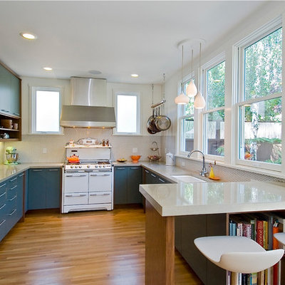 Kitchen - modern u-shaped kitchen idea in Other with flat-panel cabinets, blue cabinets, white appliances, a single-bowl sink, white backsplash and porcelain backsplash