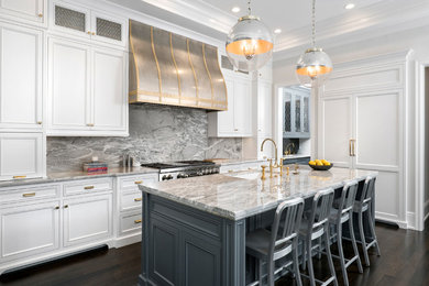 Inspiration for a large transitional u-shaped dark wood floor open concept kitchen remodel in Chicago with an undermount sink, recessed-panel cabinets, white cabinets, quartzite countertops, gray backsplash, stone slab backsplash, paneled appliances and an island