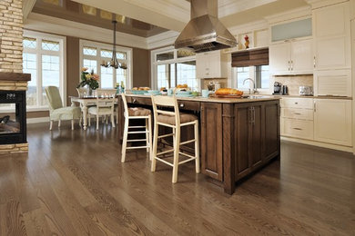 Large transitional l-shaped dark wood floor and brown floor eat-in kitchen photo in Orange County with recessed-panel cabinets, beige cabinets and an island