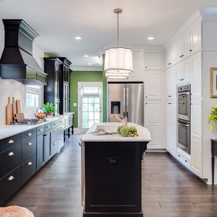 Transitional kitchen remodeling - Transitional u-shaped dark wood floor and brown floor kitchen photo in Austin with an undermount sink, flat-panel cabinets, black cabinets, white backsplash, stainless steel appliances, an island and white countertops