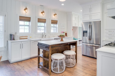 Eat-in kitchen - mid-sized cottage u-shaped medium tone wood floor and brown floor eat-in kitchen idea in Indianapolis with a farmhouse sink, shaker cabinets, white cabinets, marble countertops, white backsplash, marble backsplash, stainless steel appliances, an island and white countertops
