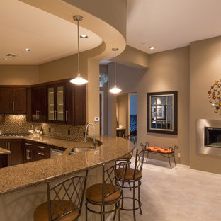 Mid-sized traditional kitchen pictures - Mid-sized elegant u-shaped travertine floor and beige floor kitchen photo in Phoenix with a double-bowl sink, shaker cabinets, brown cabinets, granite countertops, brown backsplash, mosaic tile backsplash, stainless steel appliances and an island