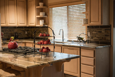 Mid-sized l-shaped light wood floor eat-in kitchen photo in Seattle with a single-bowl sink, raised-panel cabinets, quartzite countertops, gray backsplash, porcelain backsplash, stainless steel appliances and an island