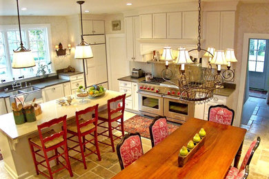 Example of a classic u-shaped eat-in kitchen design in Baltimore with a farmhouse sink, white cabinets, stainless steel appliances, shaker cabinets and quartz countertops