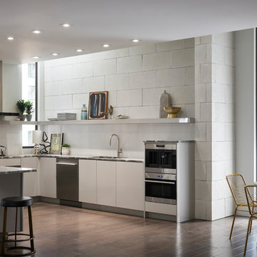 Monochromatic Modern White Stone Kitchen With Brass Fixtures